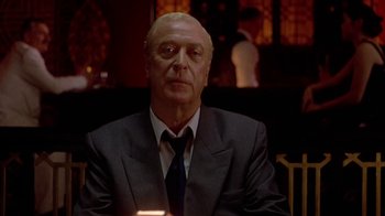 Movie still from “The Quiet American” (2002), directed by Phillip Noyce – A man in a suit and tie sitting in front of a mirror; Close Up shot, Low angle