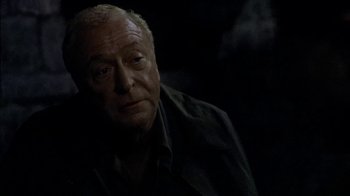 Movie still from “The Quiet American” (2002), directed by Phillip Noyce – An older man is looking into the distance; Close Up shot, Over the shoulder angle