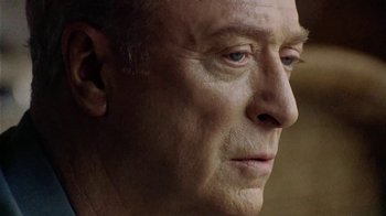 Movie still from “The Quiet American” (2002), directed by Phillip Noyce – An older man with blue eyes looking to his left; Close Up shot, Low angle