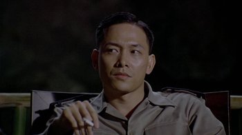 Movie still from “The Quiet American” (2002), directed by Phillip Noyce – A person holding a cell phone; Close Up shot, Low angle