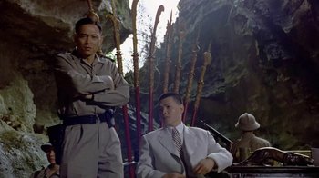 Movie still from “The Quiet American” (2002), directed by Phillip Noyce – A man in a white jacket and a man in a white suit and tie; Medium shot, Low angle