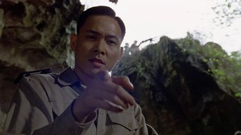 Movie still from “The Quiet American” (2002), directed by Phillip Noyce – A man in a tan jacket is talking to someone; Close Up shot, Low angle