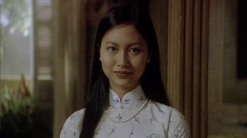 Movie still from “The Quiet American” (2002), directed by Phillip Noyce – A woman with long black hair wearing a white dress; Close Up shot, Low angle