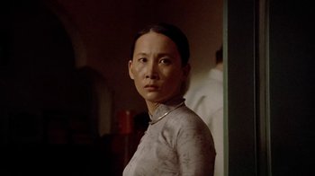 Movie still from “The Quiet American” (2002), directed by Phillip Noyce – A woman standing in front of a wall; Close Up shot, Low angle