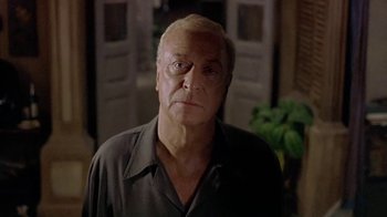 Movie still from “The Quiet American” (2002), directed by Phillip Noyce – An older man is looking at the camera; Close Up shot, Low angle
