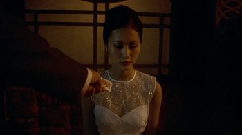 Movie still from “The Quiet American” (2002), directed by Phillip Noyce – A woman in a white dress holding a piece of paper; Close Up shot, High angle
