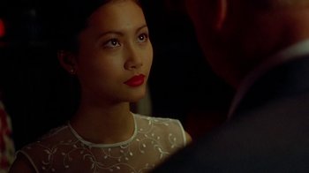 Movie still from “The Quiet American” (2002), directed by Phillip Noyce – A beautiful young lady with red lipstick looking into a mirror; Close Up shot, Over the shoulder angle