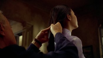 Movie still from “The Quiet American” (2002), directed by Phillip Noyce – A woman getting her hair combed by a stylist; Close Up shot, Over the shoulder angle