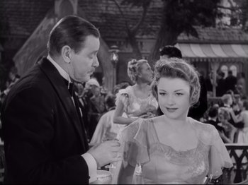 Movie still from “The Razor's Edge” (1946), directed by Edmund Goulding – A man and a woman in formal wear at an outdoor event; Medium shot, Over the shoulder angle