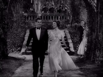 Movie still from “The Razor's Edge” (1946), directed by Edmund Goulding – A man and a woman walking down a path holding hands; Wide shot, Low angle