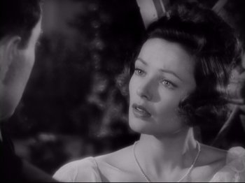 Movie still from “The Razor's Edge” (1946), directed by Edmund Goulding – A black - and - white photo of a woman in a white dress; Close Up shot, Over the shoulder angle