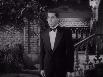 Movie still from “The Razor's Edge” (1946), directed by Edmund Goulding – A man in a tuxedo standing in front of a brick wall; Medium shot, Low angle