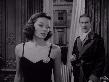 Movie still from “The Razor's Edge” (1946), directed by Edmund Goulding – A man and a woman standing next to each other in a room; Medium shot, Low angle