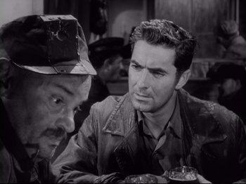 Movie still from “The Razor's Edge” (1946), directed by Edmund Goulding – Two men sitting at a table talking to each other; Close Up shot, High angle