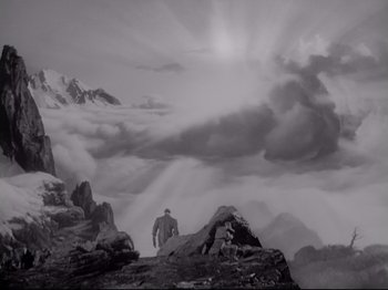 Movie still from “The Razor's Edge” (1946), directed by Edmund Goulding – A man standing on top of a mountain looking at the sky; Extreme Wide shot, Low angle
