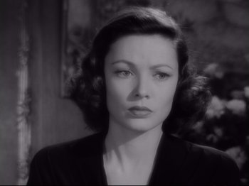 Movie still from “The Razor's Edge” (1946), directed by Edmund Goulding – A black - and - white photo of a woman in a black suit; Close Up shot, Over the shoulder angle