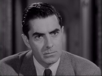 Movie still from “The Razor's Edge” (1946), directed by Edmund Goulding – A black and white photo of a man in a suit and tie; Close Up shot, High angle