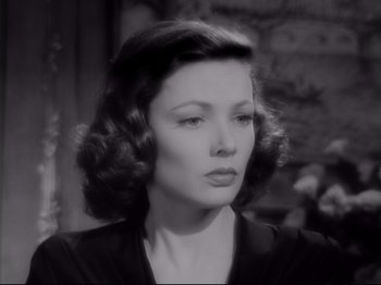 Movie still from “The Razor's Edge” (1946), directed by Edmund Goulding – A black and white photo of a woman in a black dress; Close Up shot, High angle