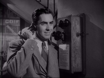 Movie still from “The Razor's Edge” (1946), directed by Edmund Goulding – An old photo of a man talking on a phone; Medium shot, Low angle