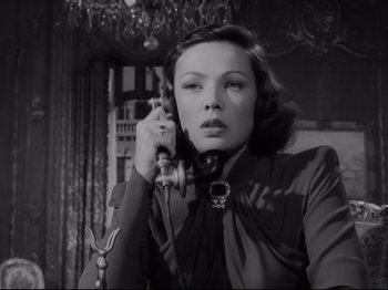 Movie still from “The Razor's Edge” (1946), directed by Edmund Goulding – A black - and - white photo of a woman talking on a phone; Close Up shot, Low angle