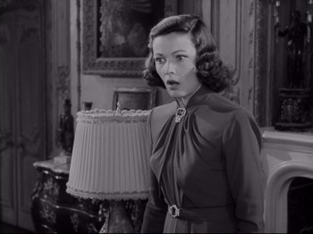 Movie still from “The Razor's Edge” (1946), directed by Edmund Goulding – A black and white photo of a woman in a dress; Close Up shot, Low angle