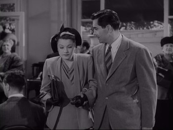 Movie still from “The Razor's Edge” (1946), directed by Edmund Goulding – A man and a woman are holding hands and smiling; Medium shot, High angle