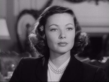Movie still from “The Razor's Edge” (1946), directed by Edmund Goulding – A black - and - white photo of a woman in a suit and pearl necklace; Close Up shot, Low angle