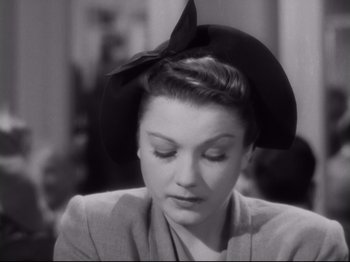 Movie still from “The Razor's Edge” (1946), directed by Edmund Goulding – A black and white photo of a woman wearing a hat; Close Up shot, High angle