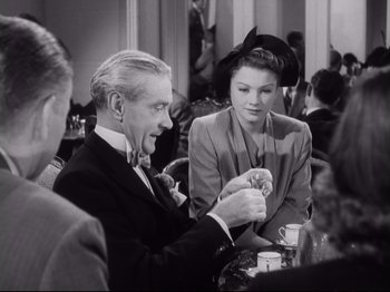 Movie still from “The Razor's Edge” (1946), directed by Edmund Goulding – A man and a woman sitting at a table; Medium shot, High angle