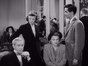 Movie still from “The Razor's Edge” (1946), directed by Edmund Goulding – A group of people sitting in a room together; Medium shot, High angle