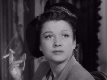 Movie still from “The Razor's Edge” (1946), directed by Edmund Goulding – An old photo of a woman smoking a cigarette; Close Up shot, High angle