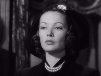 Movie still from “The Razor's Edge” (1946), directed by Edmund Goulding – An old black and white photo of a woman wearing a hat; Close Up shot, Low angle