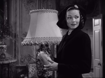 Movie still from “The Razor's Edge” (1946), directed by Edmund Goulding – A black and white photo of a woman holding a piece of bread; Medium shot, Low angle
