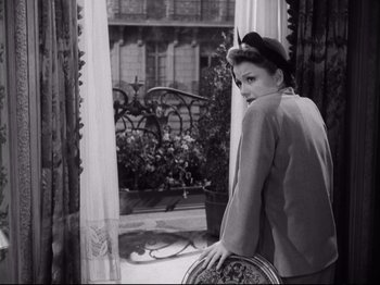 Movie still from “The Razor's Edge” (1946), directed by Edmund Goulding – A black and white photo of a woman looking out of a window; Medium shot, High angle