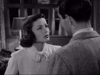Movie still from “The Razor's Edge” (1946), directed by Edmund Goulding – An old black and white photo of a man and a woman; Close Up shot, Over the shoulder angle