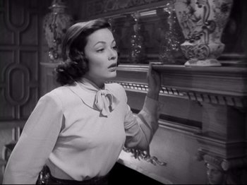 Movie still from “The Razor's Edge” (1946), directed by Edmund Goulding – An old photo of a woman looking at a mirror; Medium shot, Low angle