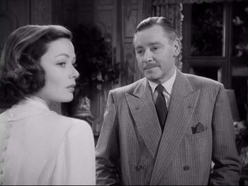 Movie still from “The Razor's Edge” (1946), directed by Edmund Goulding – An old photo of a man and a woman; Medium shot, Over the shoulder angle