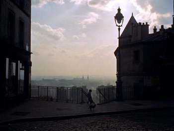 Movie still from “The Red Balloon” (1956), directed by Albert Lamorisse – A person riding a skate board on top of a ramp; Extreme Wide shot, High angle