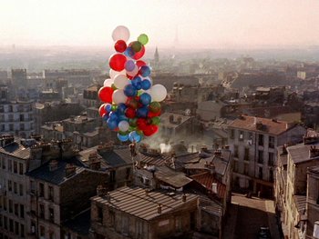 Movie still from “The Red Balloon” (1956), directed by Albert Lamorisse – A bunch of balloons that are in the air; Extreme Wide shot, Overhead angle