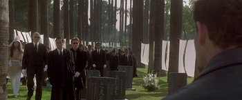 Movie still from “The Replacement Killers” (1998), directed by Antoine Fuqua – A group of men in suits and ties standing in front of a grave; Wide shot, High angle