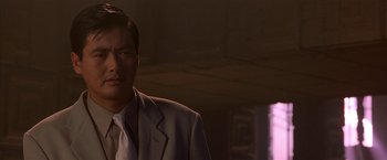 Movie still from “The Replacement Killers” (1998), directed by Antoine Fuqua – A person wearing a suit and tie; Close Up shot, Low angle