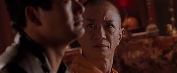 Movie still from “The Replacement Killers” (1998), directed by Antoine Fuqua – A person looking at the camera; Close Up shot, Over the shoulder angle