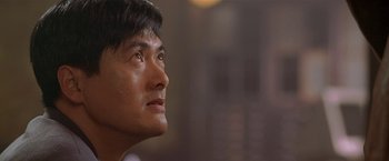 Movie still from “The Replacement Killers” (1998), directed by Antoine Fuqua – A man's face looking upward; Close Up shot, Low angle