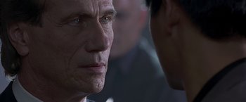 Movie still from “The Replacement Killers” (1998), directed by Antoine Fuqua – An older man looking at a younger man in front of him; Close Up shot, Over the shoulder angle