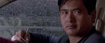 Movie still from “The Replacement Killers” (1998), directed by Antoine Fuqua – A man's face in front of a rain - covered window; Close Up shot, Low angle