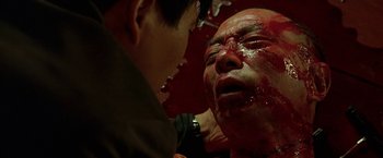 Movie still from “The Replacement Killers” (1998), directed by Antoine Fuqua – A man with blood all over his face and head; Close Up shot, Low angle