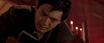 Movie still from “The Replacement Killers” (1998), directed by Antoine Fuqua – A person wearing a suit and tie; Close Up shot, Over the shoulder angle