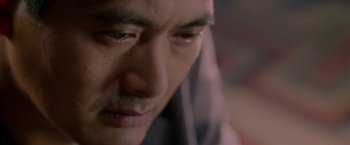 Movie still from “The Replacement Killers” (1998), directed by Antoine Fuqua – A man's face looking down; Extreme Close Up shot, Over the shoulder angle