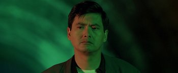 Movie still from “The Replacement Killers” (1998), directed by Antoine Fuqua – A person wearing a black shirt; Close Up shot, Low angle