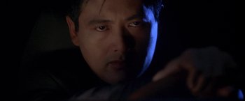 Movie still from “The Replacement Killers” (1998), directed by Antoine Fuqua – A person looking at a cell phone; Close Up shot, Low angle